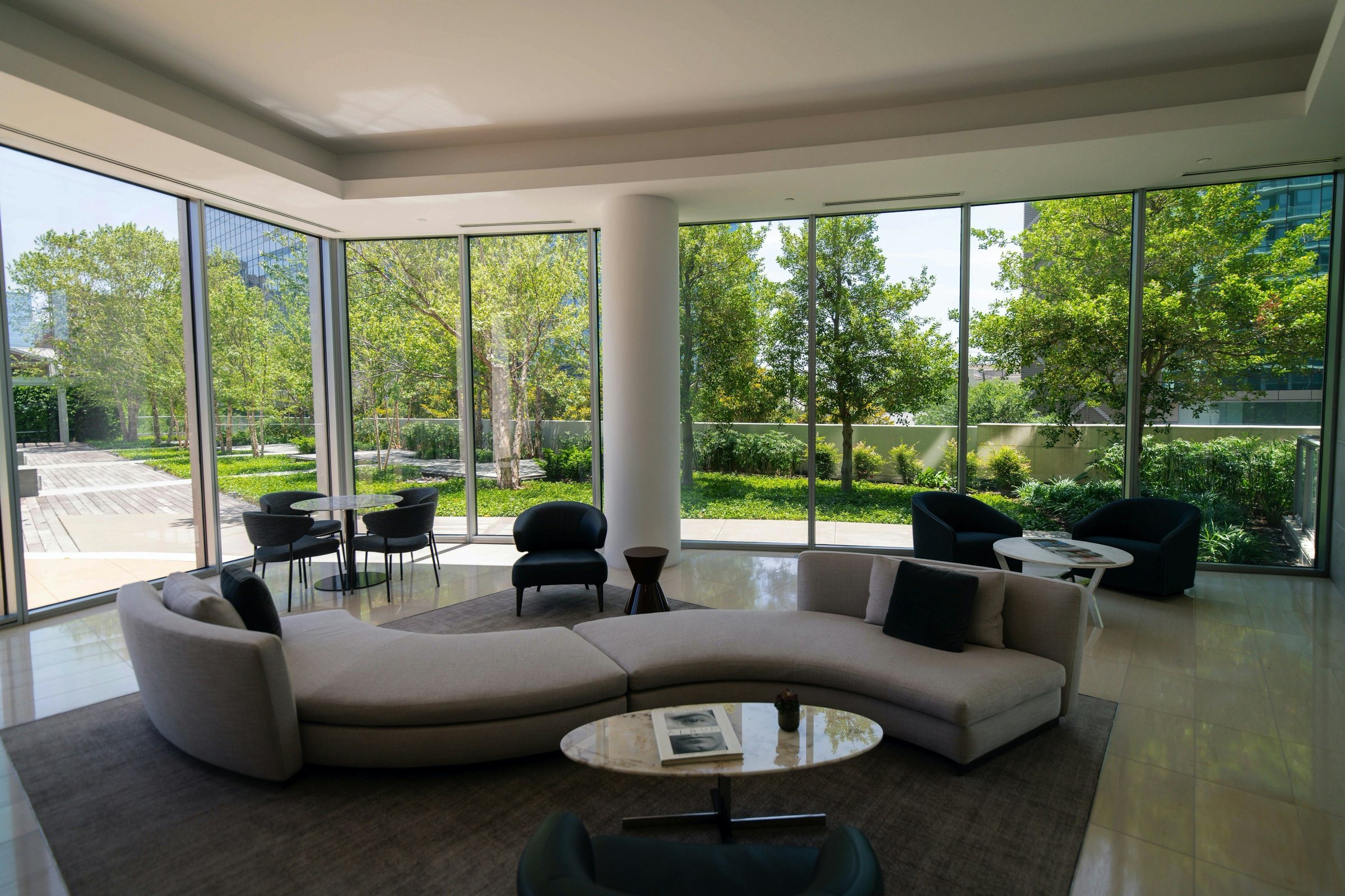 A bright living room with floor-to-ceiling windows onto a garden